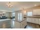 Open living space with granite island, stainless appliances, modern lighting, and comfortable seating at 3868 Sweet Iris Cir, Loganville, GA 30052