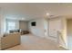 Bright loft area features a comfortable sectional sofa, a wall-mounted TV, and a double door closet at 3868 Sweet Iris Cir, Loganville, GA 30052