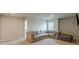 Large loft space showcases a cozy sectional, an ottoman, and a window with natural light at 3868 Sweet Iris Cir, Loganville, GA 30052
