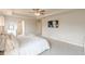 Carpeted main bedroom featuring a ceiling fan, tray ceiling and a wall-mounted television at 3868 Sweet Iris Cir, Loganville, GA 30052