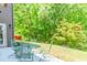 Inviting backyard patio featuring a dining set and lush green landscaping at 674 Chadmon Court Trce, Dacula, GA 30019