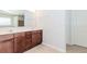 Bathroom features a double sink vanity with brown cabinets and a large mirror at 674 Chadmon Court Trce, Dacula, GA 30019