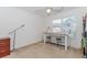 Bedroom setup as a study area with table, stools, and storage cabinet near window at 674 Chadmon Court Trce, Dacula, GA 30019