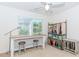 Bedroom setup as a craft room with table, stools and storage shelf near window at 674 Chadmon Court Trce, Dacula, GA 30019
