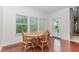 Cozy dining area features hardwood floors, windows offering natural light, and comfortable seating for four at 674 Chadmon Court Trce, Dacula, GA 30019