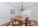 Cozy dining room featuring hardwood floors, a tray ceiling, and an elegant chandelier at 674 Chadmon Court Trce, Dacula, GA 30019