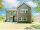 Back exterior view of a two-story home with a well-maintained lawn at 674 Chadmon Court Trce, Dacula, GA 30019