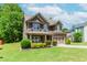 Lovely two-story home with a stone-enhanced garage, verdant lawn, and manicured landscaping at 674 Chadmon Court Trce, Dacula, GA 30019