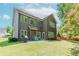 Back exterior view of a two-story home with a well-maintained lawn at 674 Chadmon Court Trce, Dacula, GA 30019