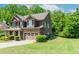 Stylish two-story home boasting a stone facade, an attached two-car garage, and meticulously maintained landscaping at 674 Chadmon Court Trce, Dacula, GA 30019