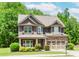 Attractive two-story house featuring a well-manicured front yard and a convenient attached two-car garage at 674 Chadmon Court Trce, Dacula, GA 30019