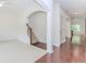Open-concept home hallway with hardwood floors, arched doorways, and white trim at 674 Chadmon Court Trce, Dacula, GA 30019