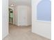 Hallway featuring neutral carpet, arched doorways, and a bright, open feel at 674 Chadmon Court Trce, Dacula, GA 30019