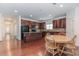 Open kitchen features a center island, wood cabinets, stainless steel appliances, and a cozy breakfast nook at 674 Chadmon Court Trce, Dacula, GA 30019
