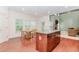 Bright kitchen boasting hardwood floors, a center island, modern lighting, and an adjacent breakfast area at 674 Chadmon Court Trce, Dacula, GA 30019