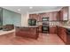 Contemporary kitchen featuring dark wood cabinetry, stainless steel appliances, and an island with an eat-in counter at 674 Chadmon Court Trce, Dacula, GA 30019