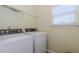 Functional laundry room with washer, dryer, window for natural light and overhead storage shelf at 674 Chadmon Court Trce, Dacula, GA 30019