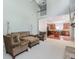 Open-concept living room with a stone fireplace, high ceilings, and kitchen view at 674 Chadmon Court Trce, Dacula, GA 30019
