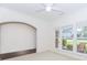 Bright living room featuring large windows, neutral carpeting, and an arched doorway at 674 Chadmon Court Trce, Dacula, GA 30019