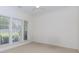 Bright room featuring a ceiling fan, large windows, and ample natural light at 674 Chadmon Court Trce, Dacula, GA 30019
