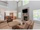 Spacious living room with a stone fireplace, high ceilings, and comfortable seating area at 674 Chadmon Court Trce, Dacula, GA 30019
