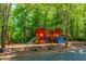 Community playground featuring colorful play equipment and a surrounding fence for safety at 674 Chadmon Court Trce, Dacula, GA 30019