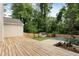 Large backyard deck, wooden fence, and lawn with mature trees providing privacy at 102 River Oaks Dr, Woodstock, GA 30188