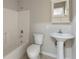 Bathroom featuring tub, toilet, and sink with storage cabinet at 102 River Oaks Dr, Woodstock, GA 30188