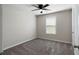 The bedroom is spacious, with carpeted floors, a ceiling fan, and neutral walls at 102 River Oaks Dr, Woodstock, GA 30188