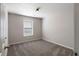This is a cozy bedroom with neutral carpet, light walls, and a window at 102 River Oaks Dr, Woodstock, GA 30188