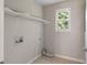 This bright laundry room has a window, shelf, and utility connections at 102 River Oaks Dr, Woodstock, GA 30188
