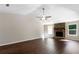 Spacious living room featuring beautiful hardwood floors and a stone fireplace at 102 River Oaks Dr, Woodstock, GA 30188