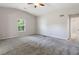 This primary bedroom boasts plush carpeting, vaulted ceilings, and a bright window at 102 River Oaks Dr, Woodstock, GA 30188