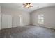 The main bedroom offers neutral carpeting, a ceiling fan, and a double door closet at 102 River Oaks Dr, Woodstock, GA 30188