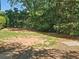 Landscaped backyard featuring a spacious lawn, mature trees, and a well-maintained yard at 1263 Linden Ne Ct, Atlanta, GA 30329