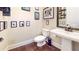 Modern bathroom with decorative wall art, pedestal sink, and hardwood floors at 1263 Linden Ne Ct, Atlanta, GA 30329