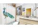 Cozy bathroom featuring granite countertops, a peacock-themed shower curtain, and neutral color palette at 1263 Linden Ne Ct, Atlanta, GA 30329
