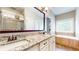 Elegant bathroom features a double sink vanity with granite counters, soaking tub, and a glass shower at 1263 Linden Ne Ct, Atlanta, GA 30329