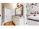 Bright bathroom boasts double vanity with granite counters and access to bedroom with red themed decor at 1263 Linden Ne Ct, Atlanta, GA 30329