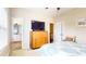 Comfortable bedroom features a vintage dresser with TV and an ensuite bathroom entrance at 1263 Linden Ne Ct, Atlanta, GA 30329