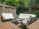 Outdoor deck with comfortable seating, and a view of the lush surrounding greenery at 1263 Linden Ne Ct, Atlanta, GA 30329
