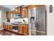 Modern kitchen featuring stainless steel appliances, granite countertops, and wood cabinetry at 1263 Linden Ne Ct, Atlanta, GA 30329