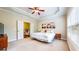 Main bedroom with ensuite, tray ceiling with fan, and natural light from double windows at 1263 Linden Ne Ct, Atlanta, GA 30329