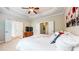 Large main bedroom with ensuite bathroom, flat screen TV, and tray ceiling with fan at 1263 Linden Ne Ct, Atlanta, GA 30329