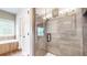 Stunning glass enclosed shower boasts tile surround with a dark hardware and view of soaking tub at 1263 Linden Ne Ct, Atlanta, GA 30329
