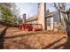This backyard features a spacious red deck with plenty of room for outdoor entertaining at 2269 Howell Farms Nw Trl, Acworth, GA 30101