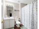 Bathroom with a seashell-themed shower curtain, white vanity, and wood-look flooring at 2269 Howell Farms Nw Trl, Acworth, GA 30101