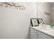 Half bathroom with white vanity, framed coastal artwork, and decorative mirror at 2269 Howell Farms Nw Trl, Acworth, GA 30101