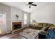 Bright living room featuring a brick fireplace, ceiling fan, and hardwood floors at 2269 Howell Farms Nw Trl, Acworth, GA 30101