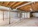An unfinished basement space showing exposed beams, support columns and a concrete foundation at 2585 Whisper Trail, Douglasville, GA 30135